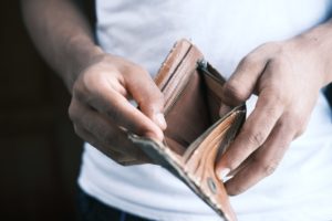Man opens empty wallet, no money